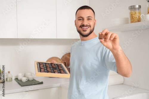 Young man with box of choco...