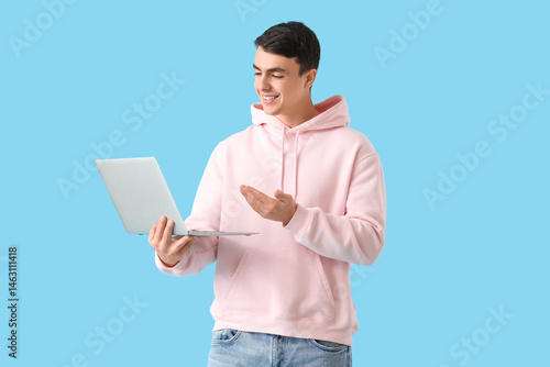 Young man with laptop video...
