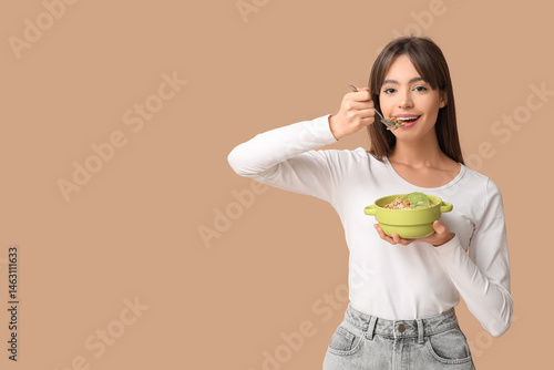 Young woman eating tasty gr...