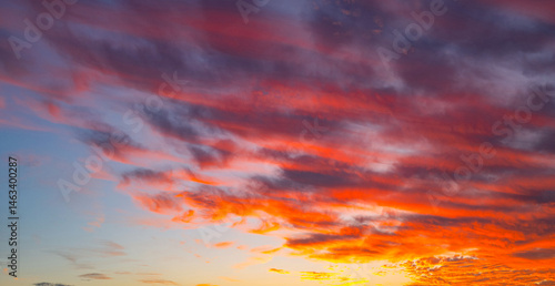 Obraz na płótnie Sky at sunrise. Sunset background. Sunrise through clouds on sky. Twilight sky with sunrise colors. Peaceful dawn with soft light. Dramatic dusk sunrise with clouds. Sunshine in clear sky. w salonie
