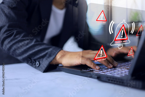 Φωτογραφία System alert concept with businessman working on laptop screen and receiving software alerts about cyber intrusion or attempted ransomware attack