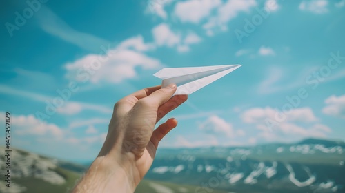 Hand Holding a Paper Airplane: A hand launching a paper airplane, symbolizing creativity and play. 
