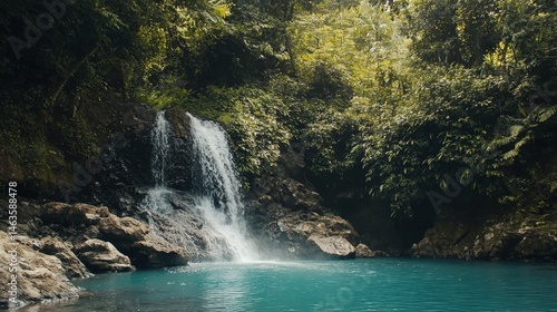 Jungle waterfall cascade in tropical forest with rock and turquoise blue pond