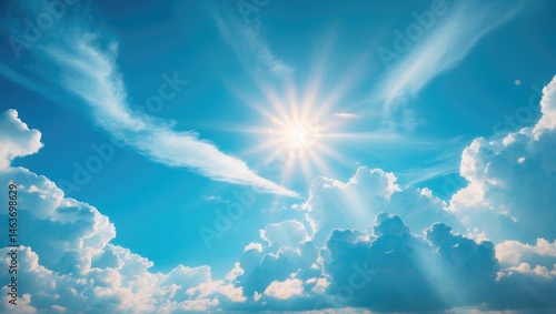 Sunny summer day featuring a blue sky, white clouds, and radiant sun reflection