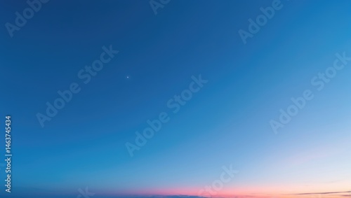 Fototapeta Naklejka Na Ścianę i Meble -  A beautiful, clear summer sky with no clouds, showcasing a gradient of blue, orange, and pink hues at the horizon.