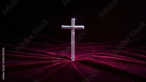Glowing Cross Formed from Braided Silver Wires on Velvet Background