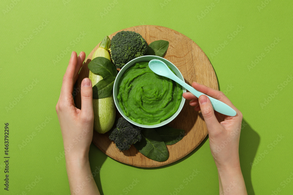 Children's vegetable and fruit puree, on a green background.