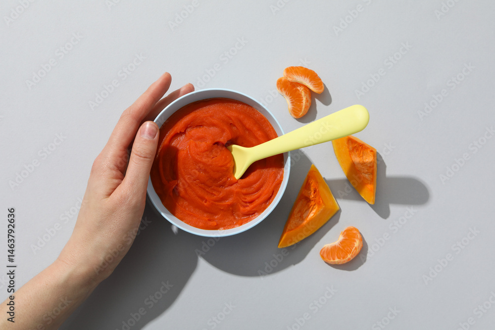 Children's vegetable and fruit puree, on a light background.