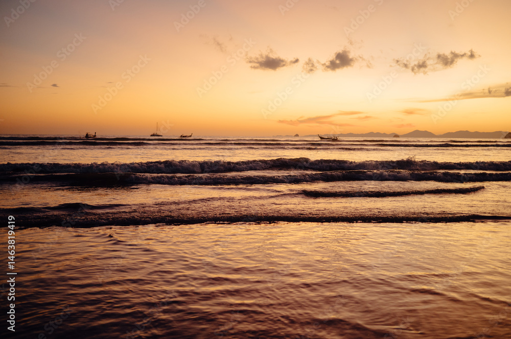 Obraz premium Longtail Boat Silhouettes at Sunset, Ao Nang Beach, Krabi, Thailand