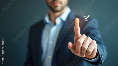 Hand of a businessman tapping the check sign on a flag. Concept of business strategy, approval, quality control and right choice. Clean and minimalistic setting.