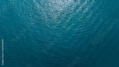 Aerial zenith view of the deep and blue water of the sea. Empty surface of water. Ideal for textures, patterns and backgrounds.