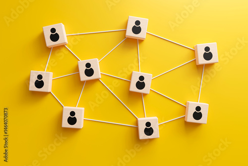 Wooden cubes with people icon linked to each other with lines on yellow background. online communication or social networking concept, 3d render

