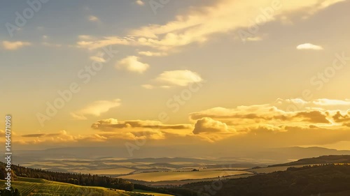 Fluffy White Clouds in a Bright Blue Sky Over a Beautiful Landscape