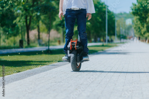 Wallpaper Mural Man with electric unicycle in park on a sunny day closeup view Torontodigital.ca
