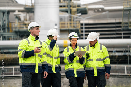 Canvas Print Group of engineer workers checking project at petrochemical factory or refinery oil plant industrial