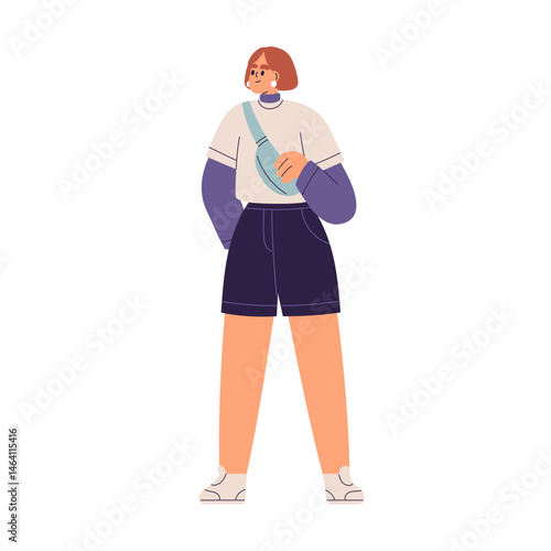 Girl standing in urban style outfit with cross-body bag. Young modern woman i...