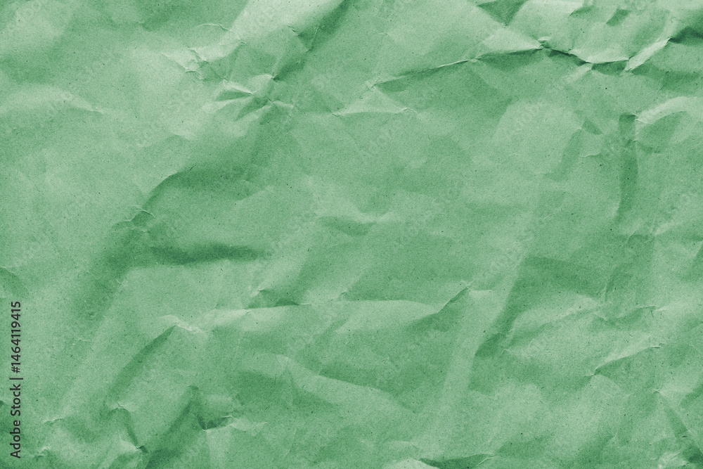 Obraz premium Recycled crumpled green colored paper texture. Wrinkled craft paper background, rough cardboard surface, wallpaper, backdrop. Design element, copy space for text