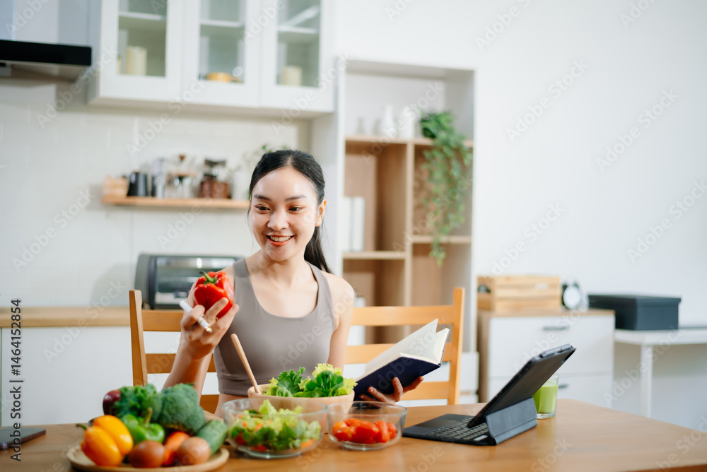 Female athete in sportswear standing in kitchen in sportswear and writing down healthy recipe. Active healthy lifestyle, clean eating Female athete in sportswear standing in kitchen in sportswear and writing down healthy recipe. Active healthy lifestyle, clean eating