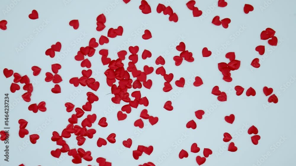 Decorative small red hearts spinning in circle on white background