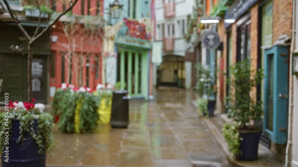 Blurred view of neals yard in london showcasing vibrant street colors and plants on a rainy winter day. Blurred view of neals yard in london showcasing vibrant street colors and plants on a rainy winter day.