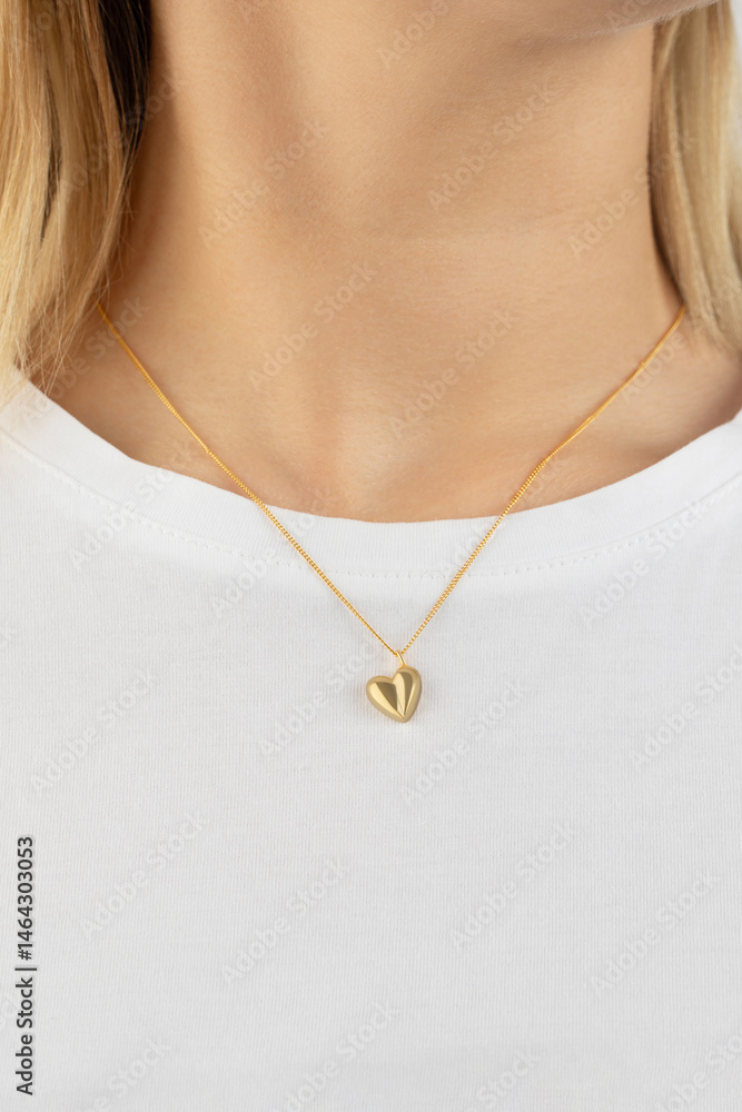 Φωτογραφία Female wearing heart-shaped gold pendant on chain necklace over white shirt