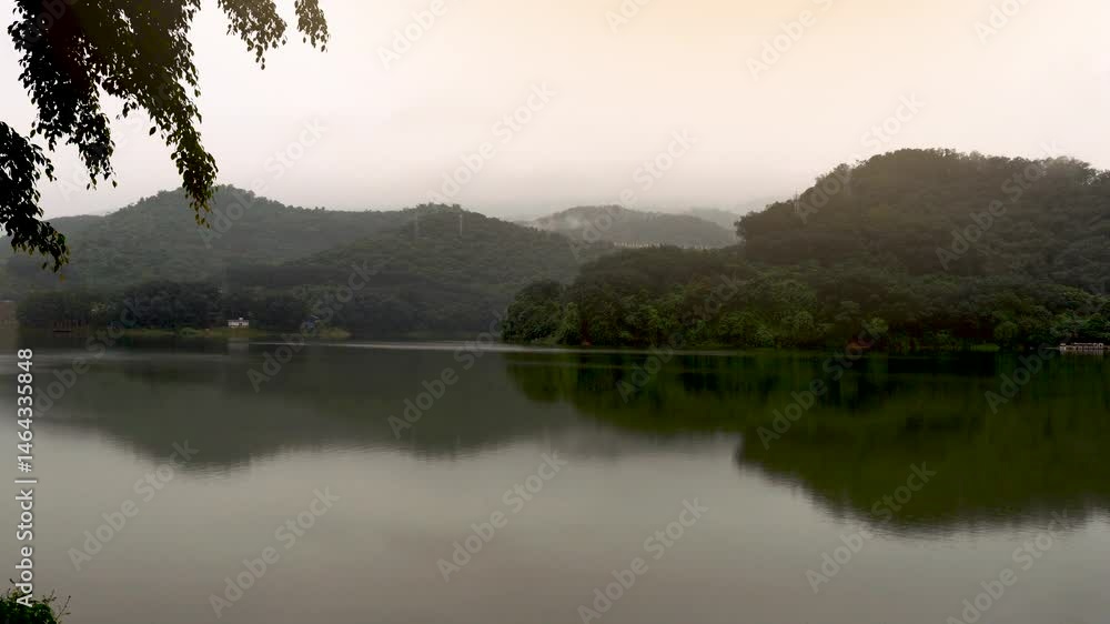Early morning fog envelops serene mountain lake landscape Early morning fog envelops serene mountain lake landscape