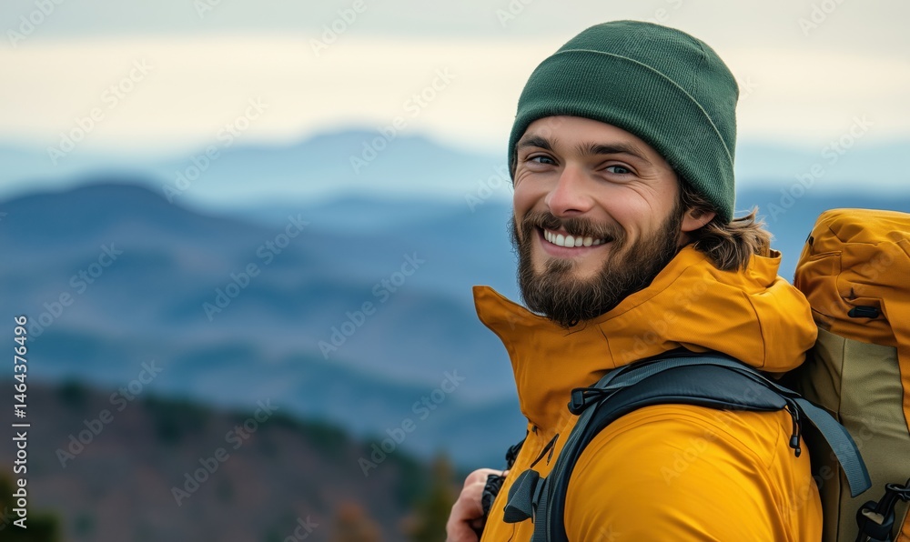 Smiling hiker in yellow jacket with backpack against mountain landscape Smiling hiker in yellow jacket with backpack against mountain landscape