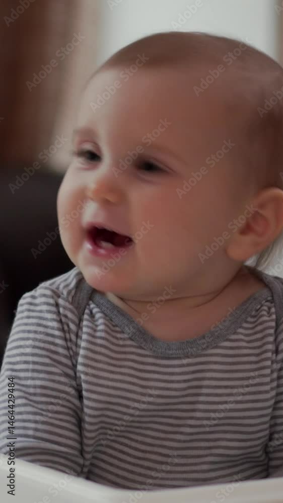 Mother feeding baby breakfast, eating in the kitchen at home, providing care and enjoyment during a nurturing mealtime. Vertical video. Mother feeding baby breakfast, eating in the kitchen at home, providing care and enjoyment during a nurturing mealtime. Vertical video.