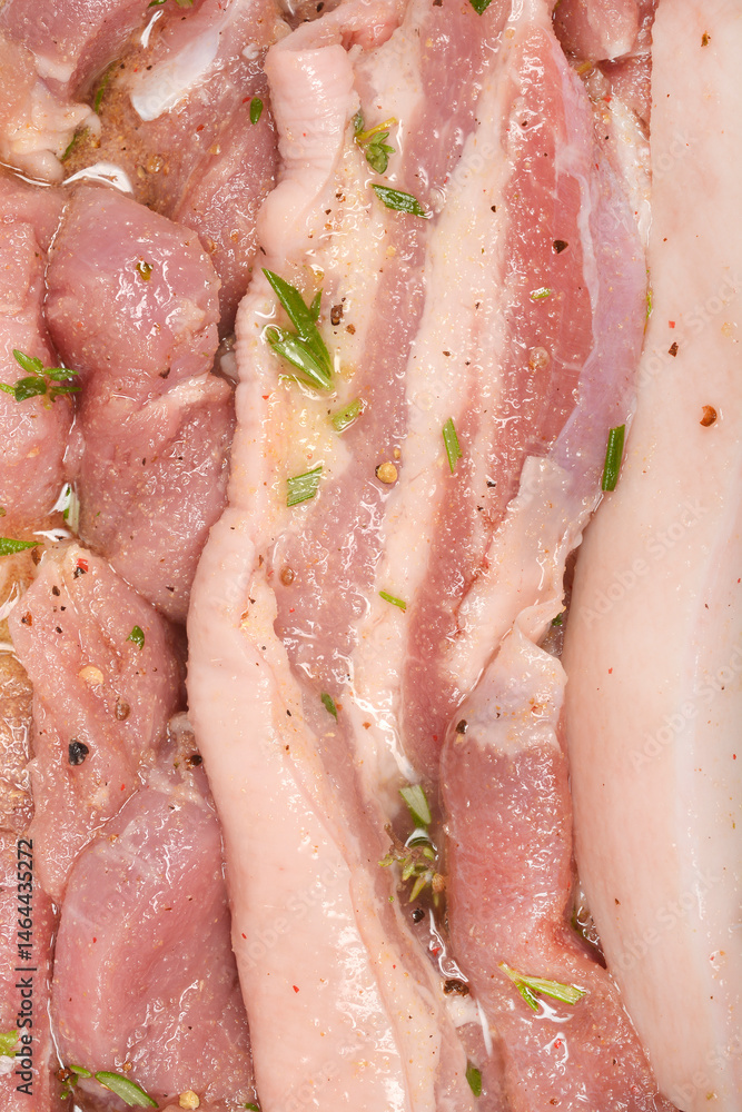 A close-up shows raw pork belly pieces marinating in a liquid with visible herbs and spices