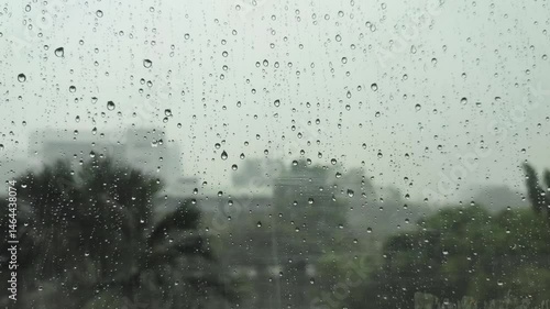 Morning rain on the window of a building with a slightly foggy background