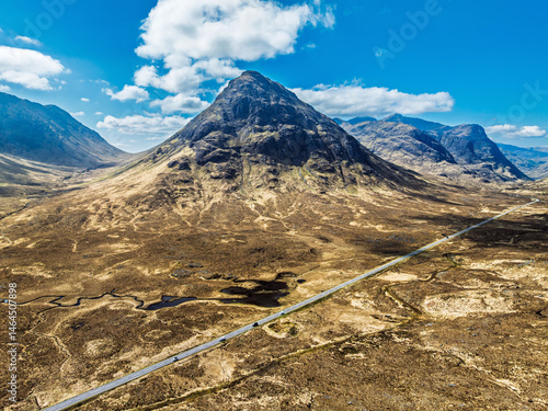 Buachaille Etive Beag and Three Sisters in Glencoe over Moors and Road A82 from a drone, Highlands, Scotland