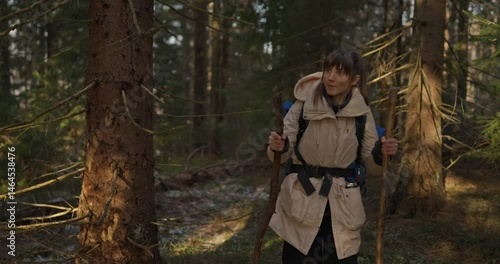 Wallpaper Mural Girl in hiking clothes with a large backpack finds her way among branches and trees during a trip in a sunny spring forest. Journey into the Wild Forest Torontodigital.ca