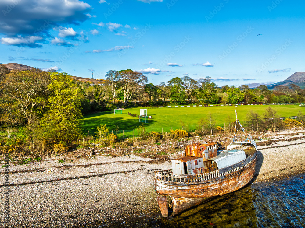 View of Corpach Wreck or Old Boat of Caol and Nevis Range Mountains from a drone, Caol Beach, Corpach, Fort William, Highland, Scotland