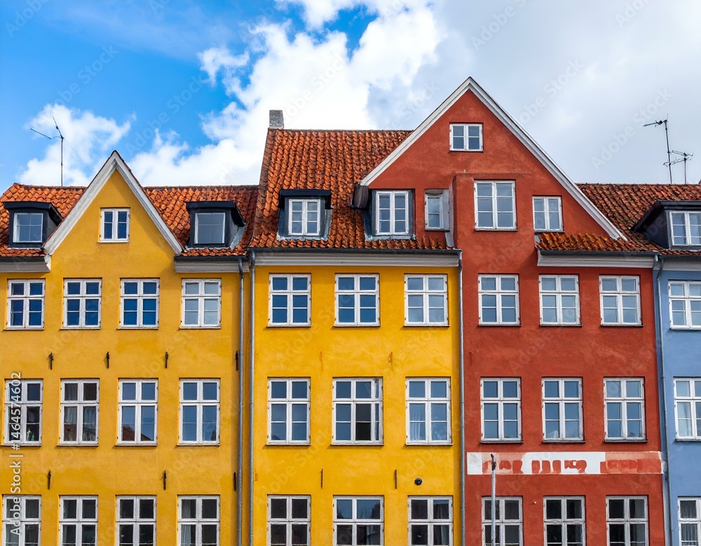 Fototapeta premium Colorful European houses under a vibrant blue sky. Perfect for travel, architecture, and real estate projects.
