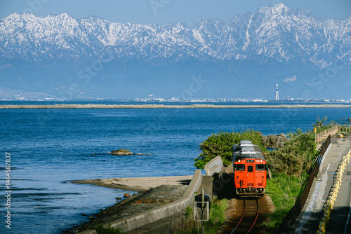 Local Train Running Along the Toyama Bay with Tateyama Mountains in the Background – Toyama, Japan, May 8, 2025