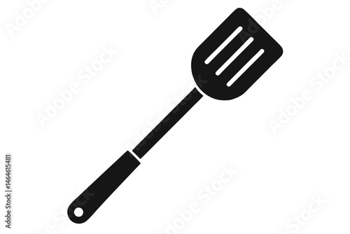 Solid black spatula with three slots and long handle rests diagonally on white