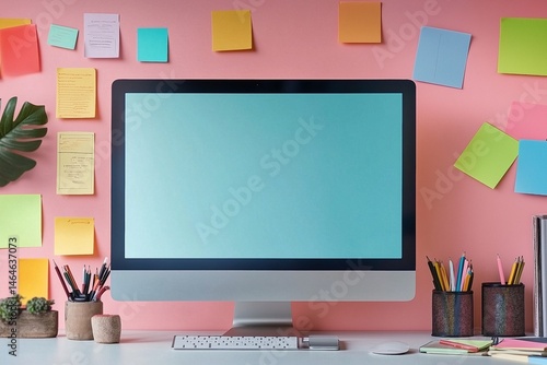 Comfortable worksplace mockup rendering, desktop monitor screen surrounded by colorful post-it notes attached on the wall