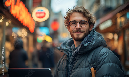 Smiling Man with Laptop in City Street