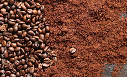 Coffee beans and ground coffee background. Roasted coffee beans on dark wooden background. Invigorating drink. Copy space. Top view of beans and coffee powder