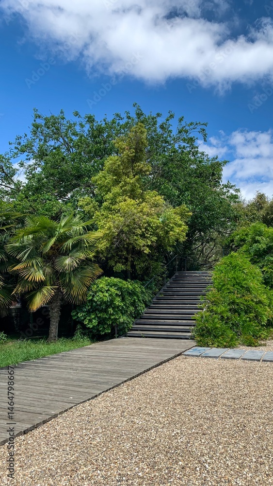 Serpentine garden path amidst verdant foliage, whispering wanderlust, echoes Earth Day tranquility and Obon meditation retreat Serpentine garden path amidst verdant foliage, whispering wanderlust, echoes Earth Day tranquility and Obon meditation retreat