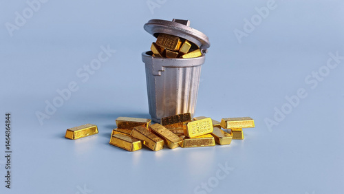 Obraz na plátne Overturned Trash Can Filled with Gold Bars Representing Misplaced Value, Wealth