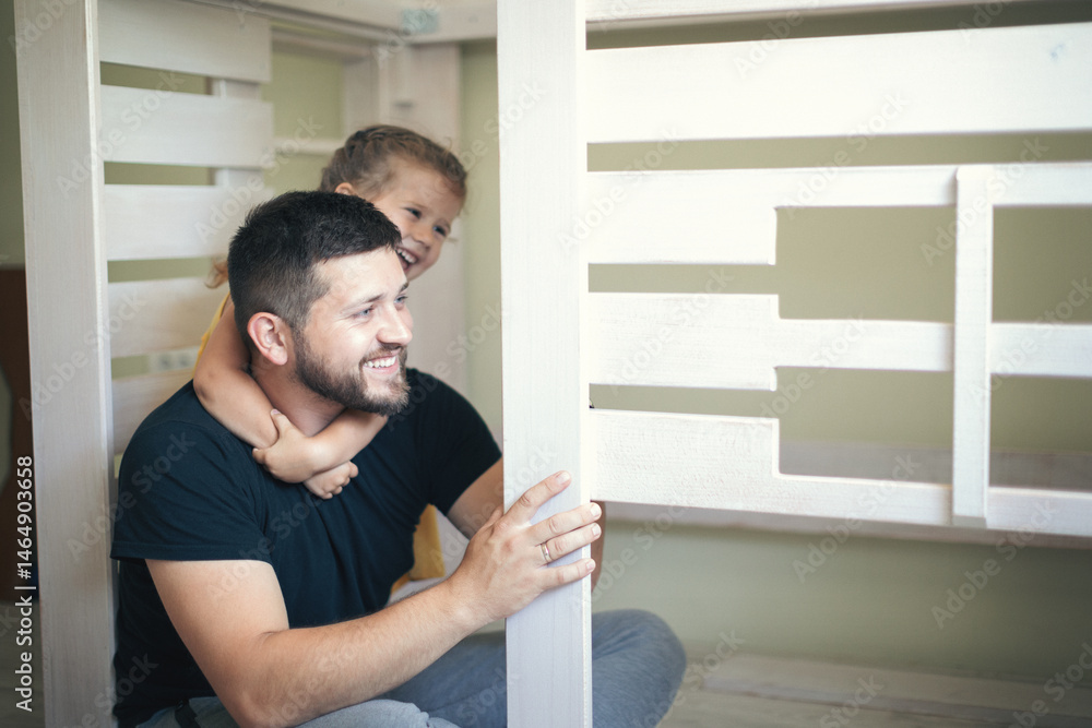 Young man with his daughter assembling furniture at home Young man with his daughter assembling furniture at home