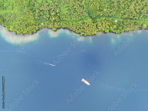 An extensive rainforest covers a remote, tropical island near Halmahera, Indonesia.This beautiful area is home to extraordinary marine and terrestrial biodiversity.