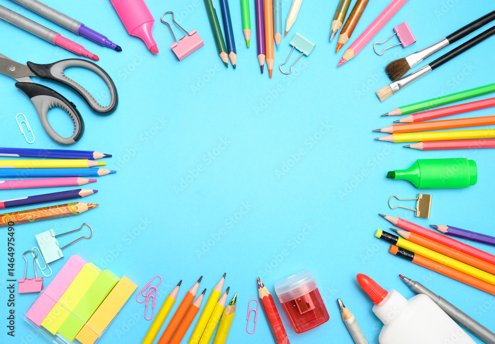 Fototapeta premium Flat lay of colorful school stationery arranged in a circle on blue background with empty space for text. Perfect for back to school banners or educational ads.