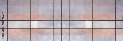 Long banner. Background of windows of a glass modern building close up.