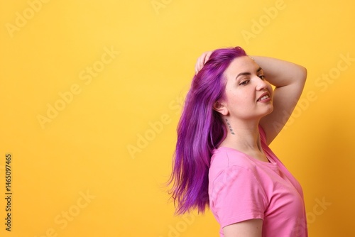 Fotografie Beautiful woman with bright purple hair and tattoo in Chinese on yellow background