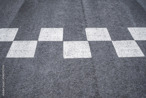 Close-up of road markings at the race start and finish.