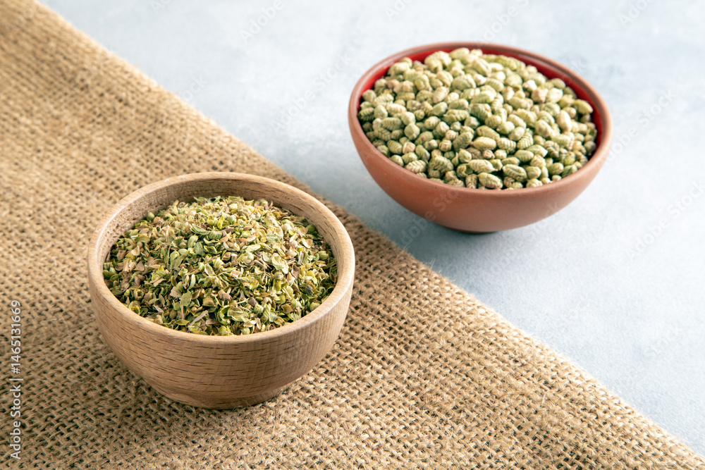Bowls of dried and ground natural mountain thyme on a light background Bowls of dried and ground natural mountain thyme on a light background