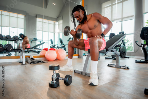 Muscular man performs various strength training exercises with dumbbells in a modern gym, showcasing power, focus, and dedication to fitness.
