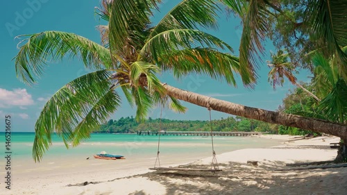 Tropical beach with palm tree and silhouette travel people on kayak in ocean on background colorful sunset. Summer holidays in tropical paradise concept